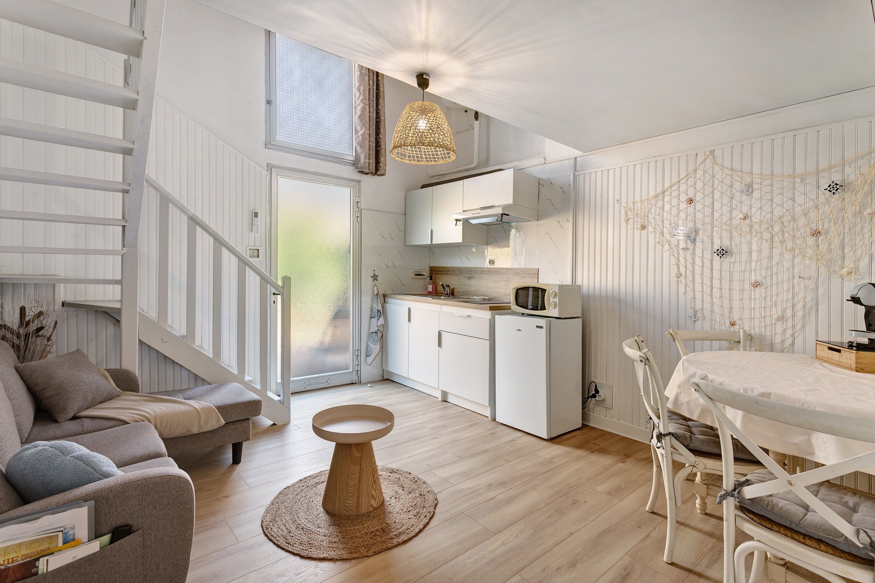 Een modern interieur met een trap, een eethoek en een keuken.