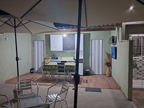 Eine kompakte Küche mit Essbereich, Deckenventilator und einem kleinen Tisch mit Stühlen.