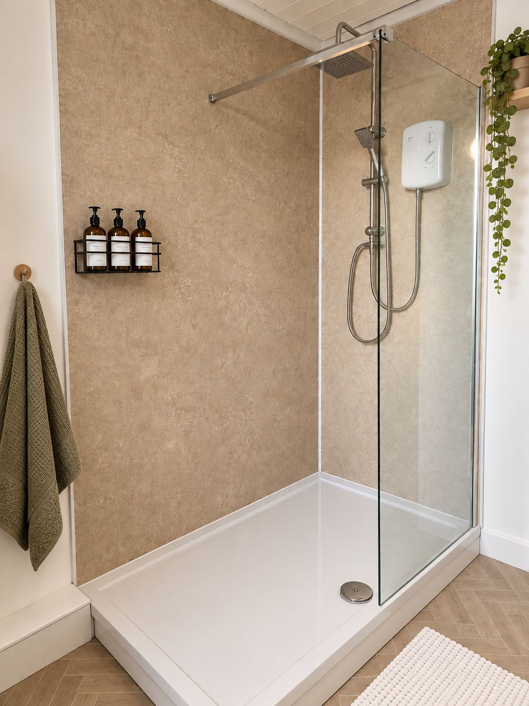A glass-enclosed shower with a handheld showerhead and a wall-mounted control panel.