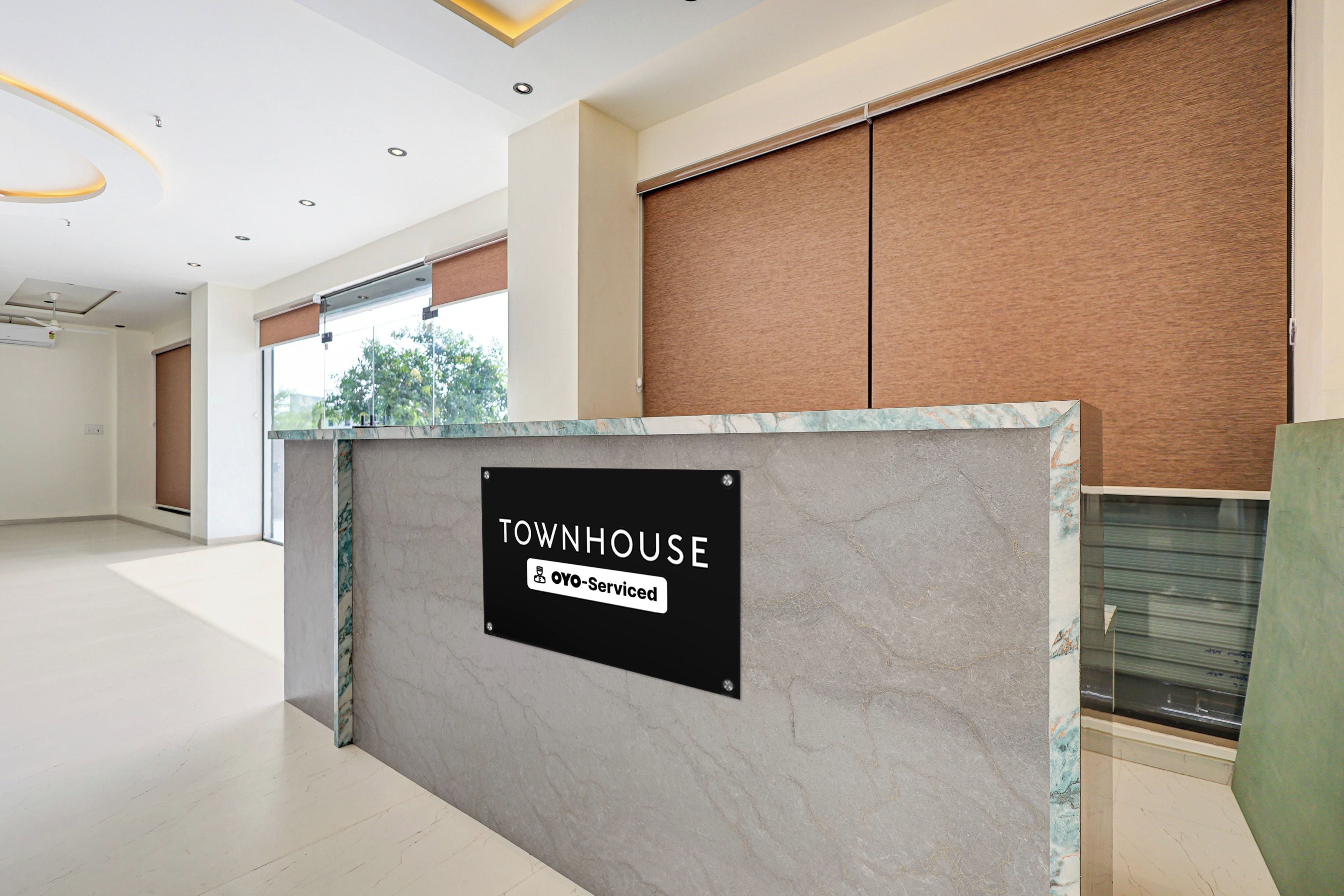 A reception area with a sign indicating it is a serviced townhouse.