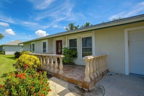 A single-story house with a front porch, a garage, and a well-maintained lawn. - Family Oasis w/ Private Pool in Cape Coral! (Cape Coral)