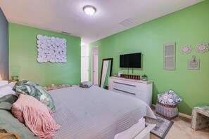 A bedroom with a bed, dresser, TV, and decorative items. - 8 Mi to Disney! Whimsical Home w/ Pool & Game Room (Kissimmee)