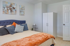 A bedroom with a bed, a wardrobe, and two paintings on the wall. - Suburban Snowbird Escape 22 Mi to Dtwn Fort Myers (Fort Myers)