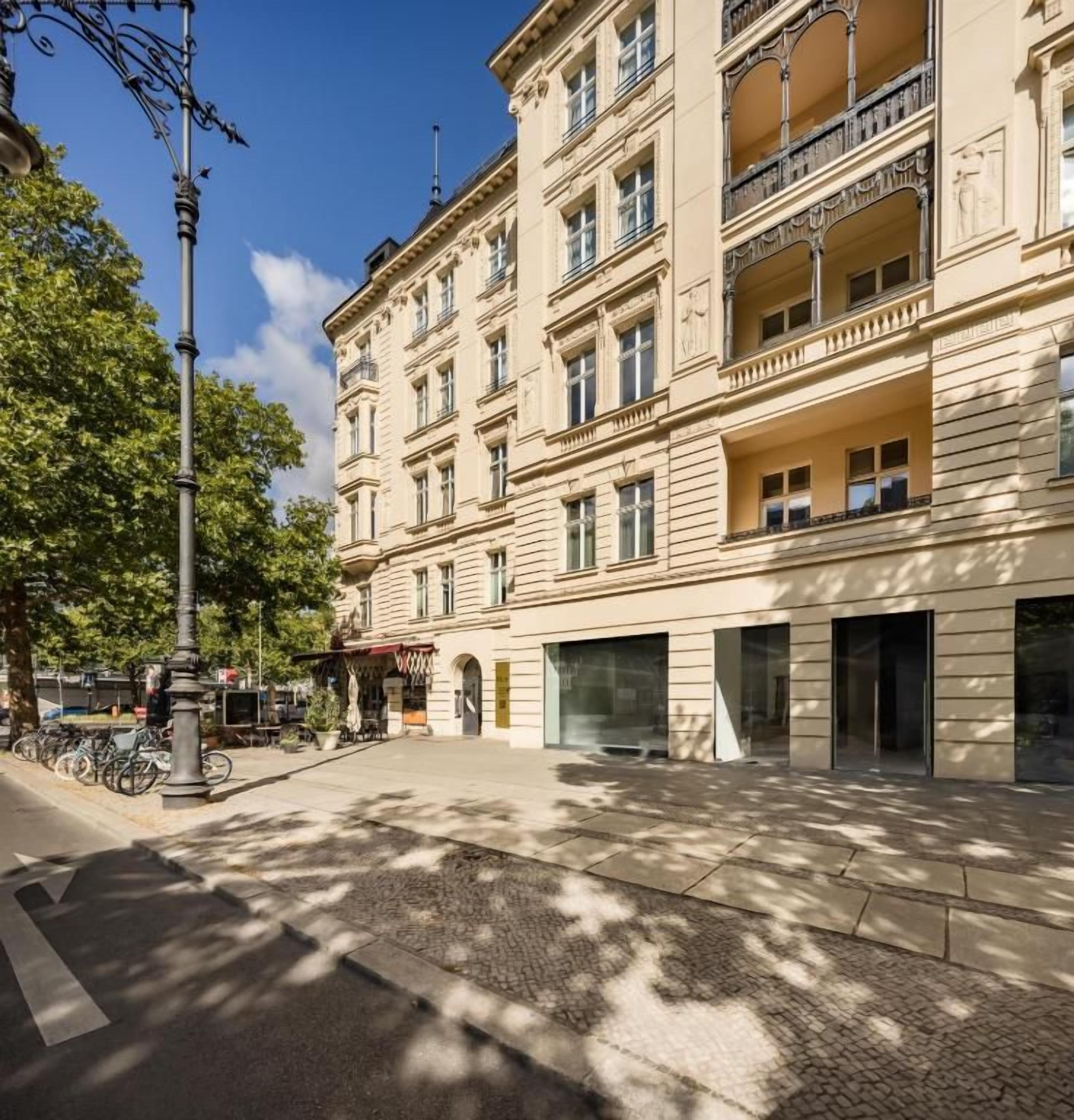 A multi-story building with a classic architectural style, featuring balconies and large windows.