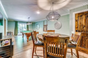 A room with a pool table, wooden chairs, a round table, and a hanging light fixture. - Cold Mountain Cabin W/hot Tub, Pool Table & Views (Canton)