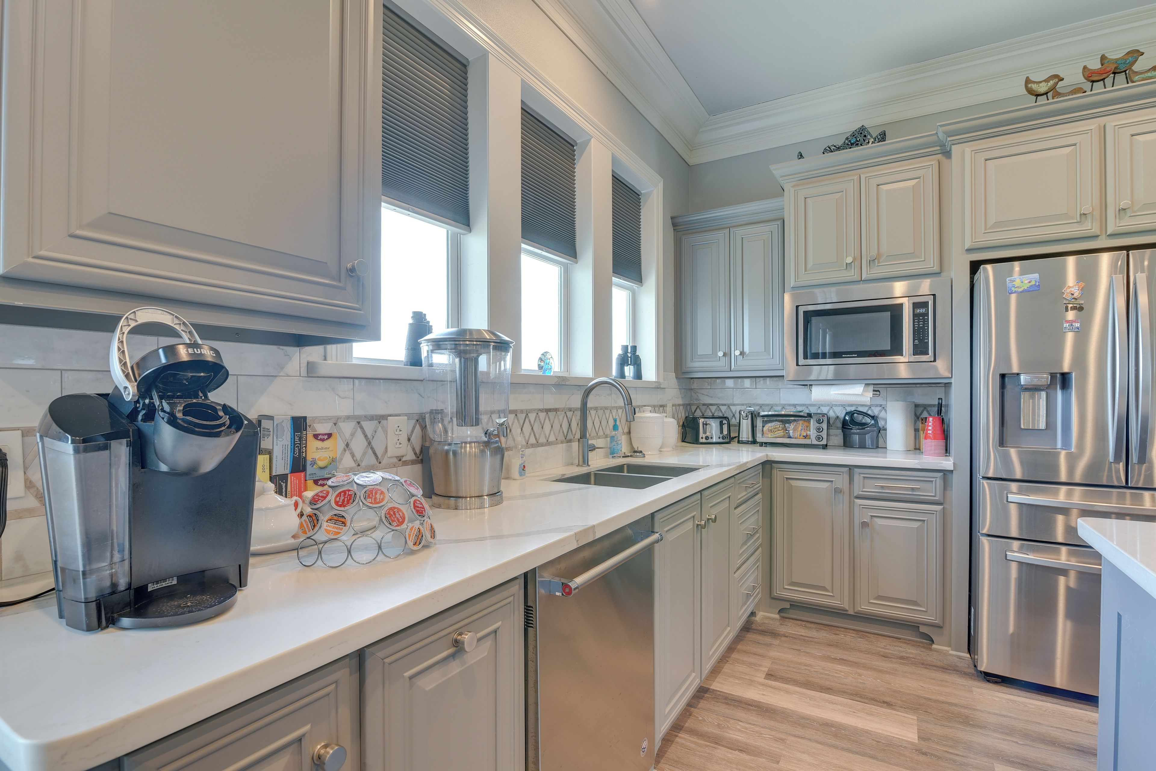 A modern kitchen with stainless steel appliances, a dishwasher, and a microwave.
