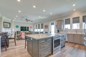 A spacious kitchen with a large island, built-in appliances, and ample counter space.