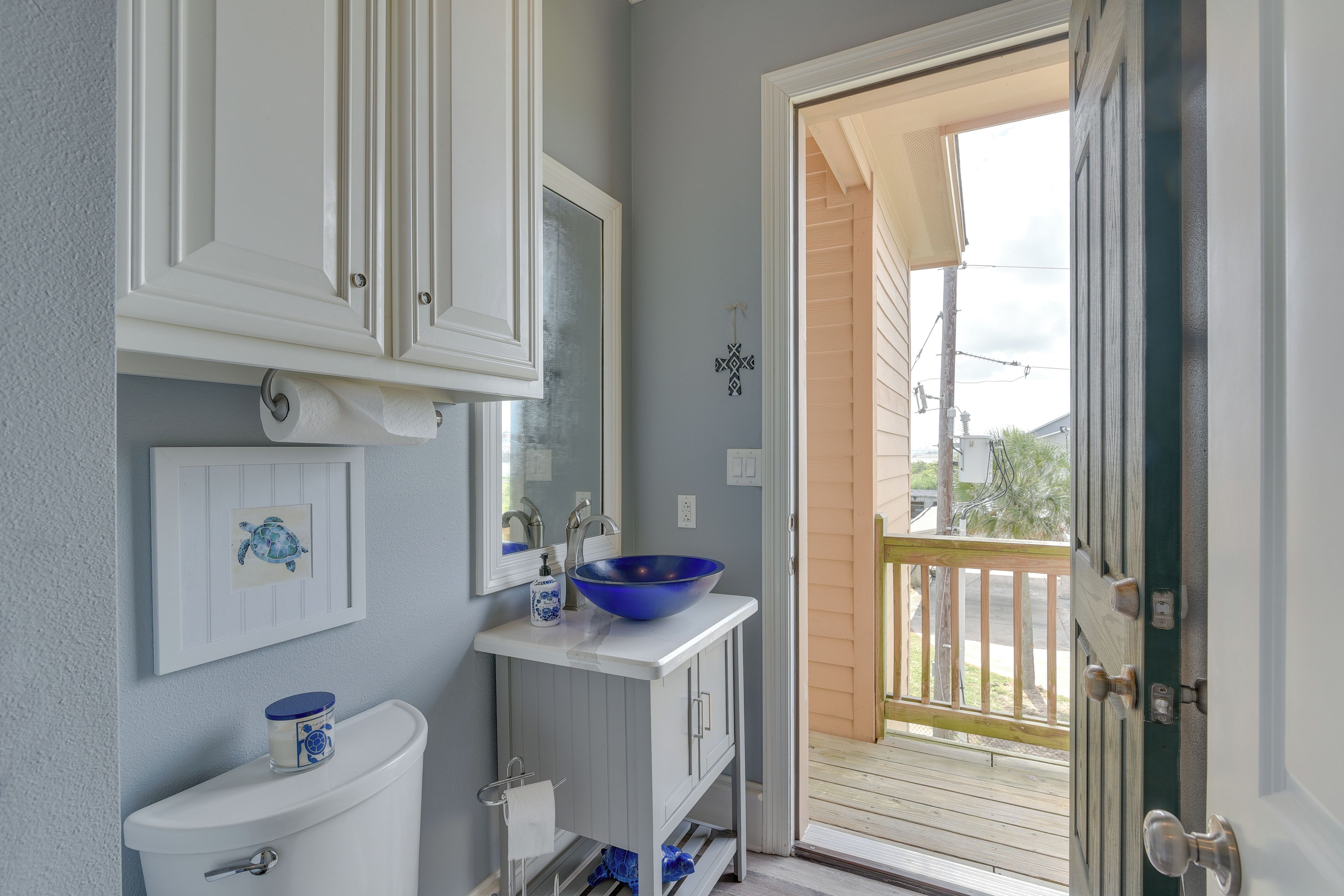 A bathroom with a toilet, sink, and blue basin.