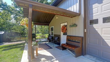 A covered outdoor area with a bench and a sign reading 'Northwood Lodge.'