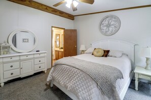 A bedroom with a bed, dresser, and a round mirror. - Recently Remodeled! Hillsboro Home w/ Fire Pit (Hillsboro)