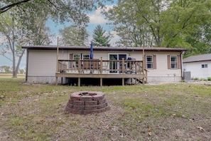 A single-story house with a porch, a brick fire pit, and a clear sky. - Recently Remodeled! Hillsboro Home w/ Fire Pit (Hillsboro)