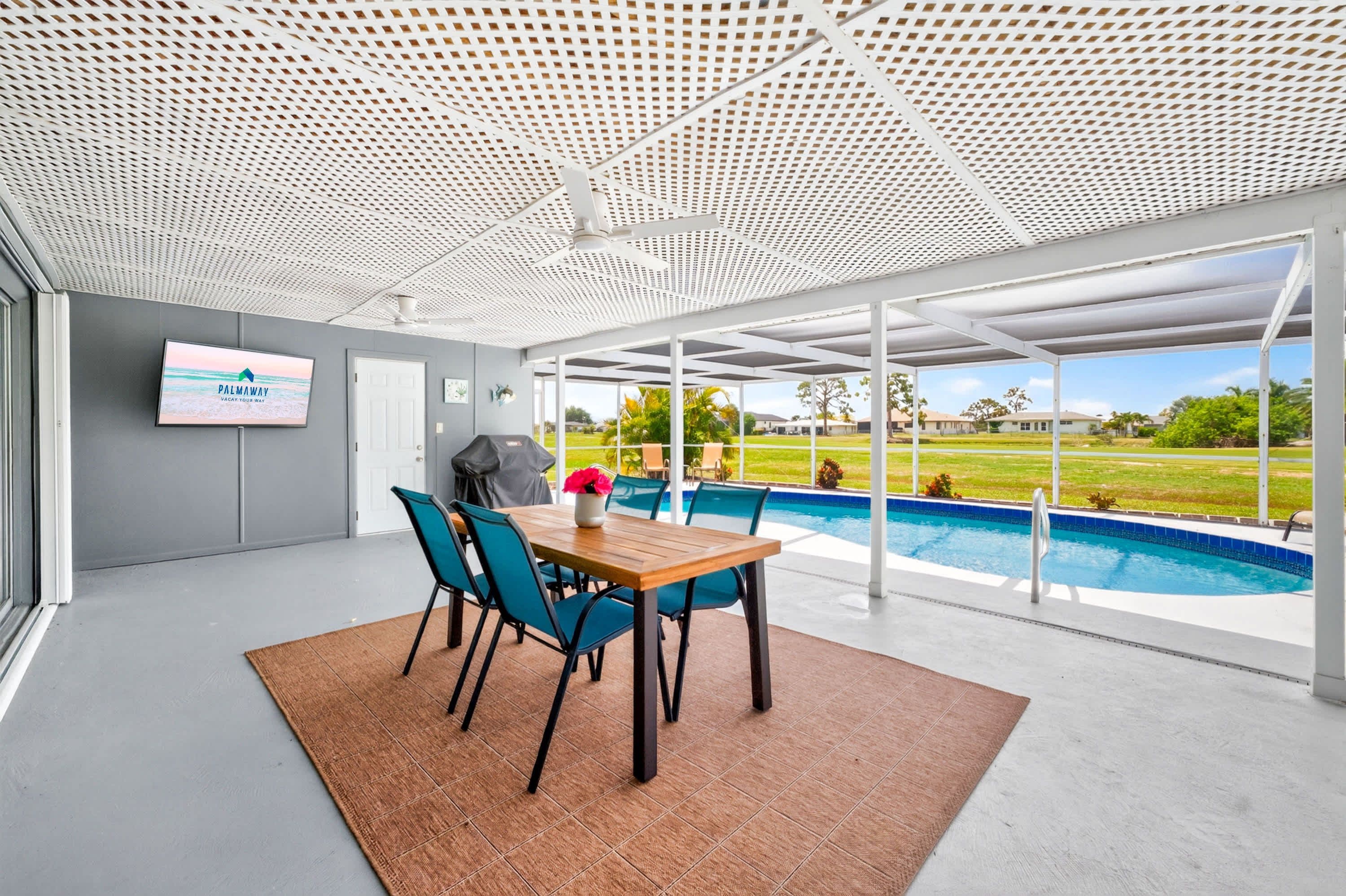 A modern indoor pool area with a view of a residential neighborhood.