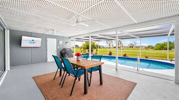 A modern indoor pool area with a view of a residential neighborhood.