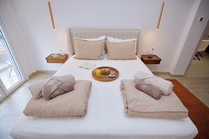 A modern bedroom with a large bed, bedside tables, and a tray with breakfast items. - Boutique stay in Athens center (Athina)