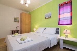 Una camera da letto con un letto, comodini, un armadio e un quadro appeso al muro.
