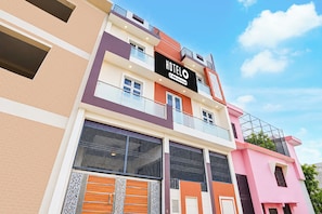 A multi-story hotel building with a prominent 'HOTEL' sign, balconies, and a modern architectural design. - Hotel O Ayodhya Junction Road (Faizabad)