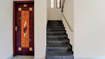 A staircase with a wooden door marked with the number 103.