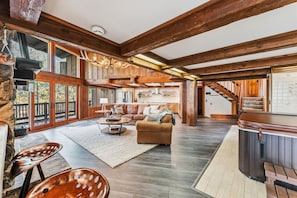 A spacious living area with a fireplace, a sofa, and a dining table. - Silverthorne Mountain Retreat Hot Tub Sauna Near Keystone Breck and Copper (Silverthorne)