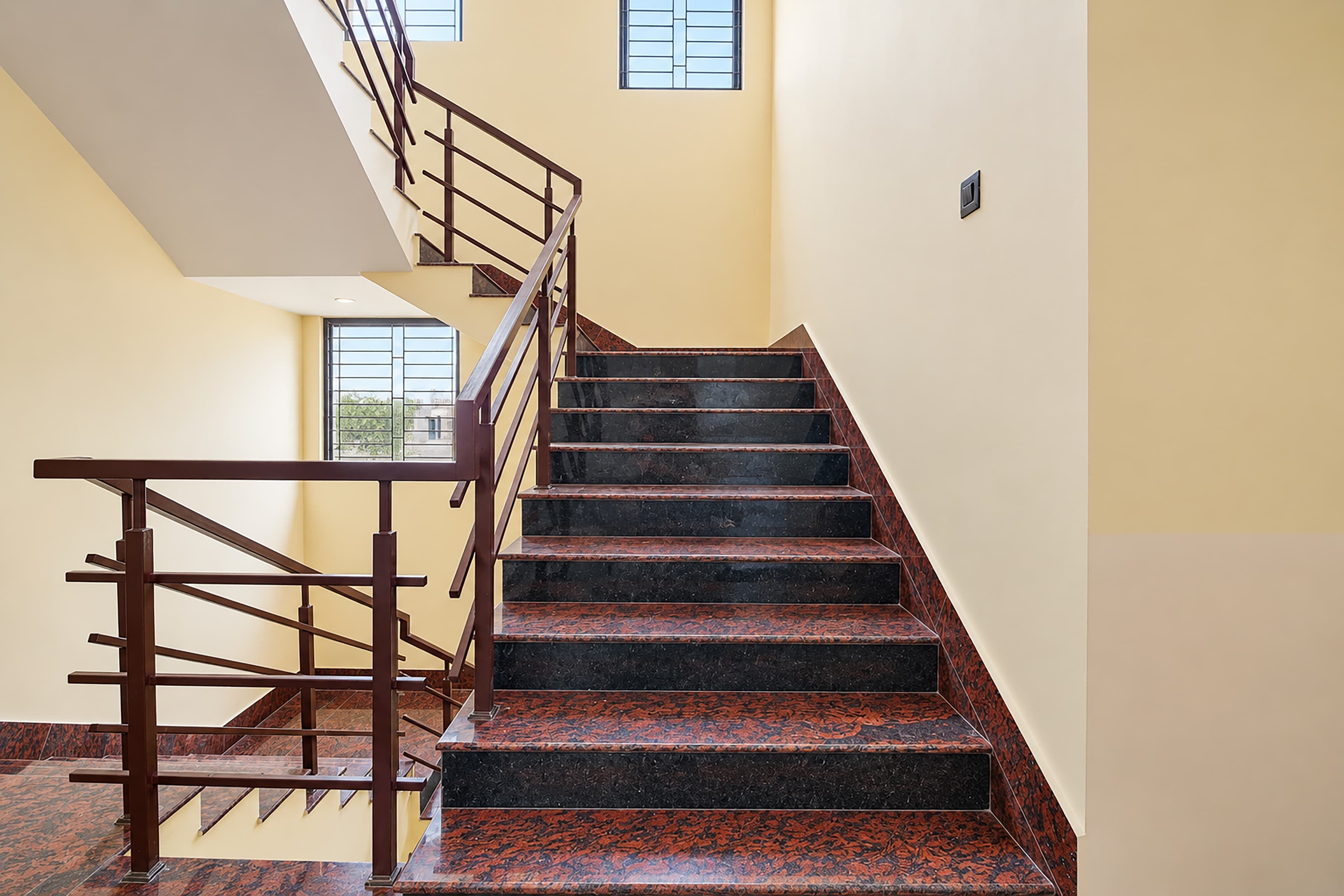 A staircase with a handrail and a landing area.
