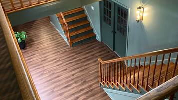 A multi-level wooden staircase with a railing, connecting different floors of a building.