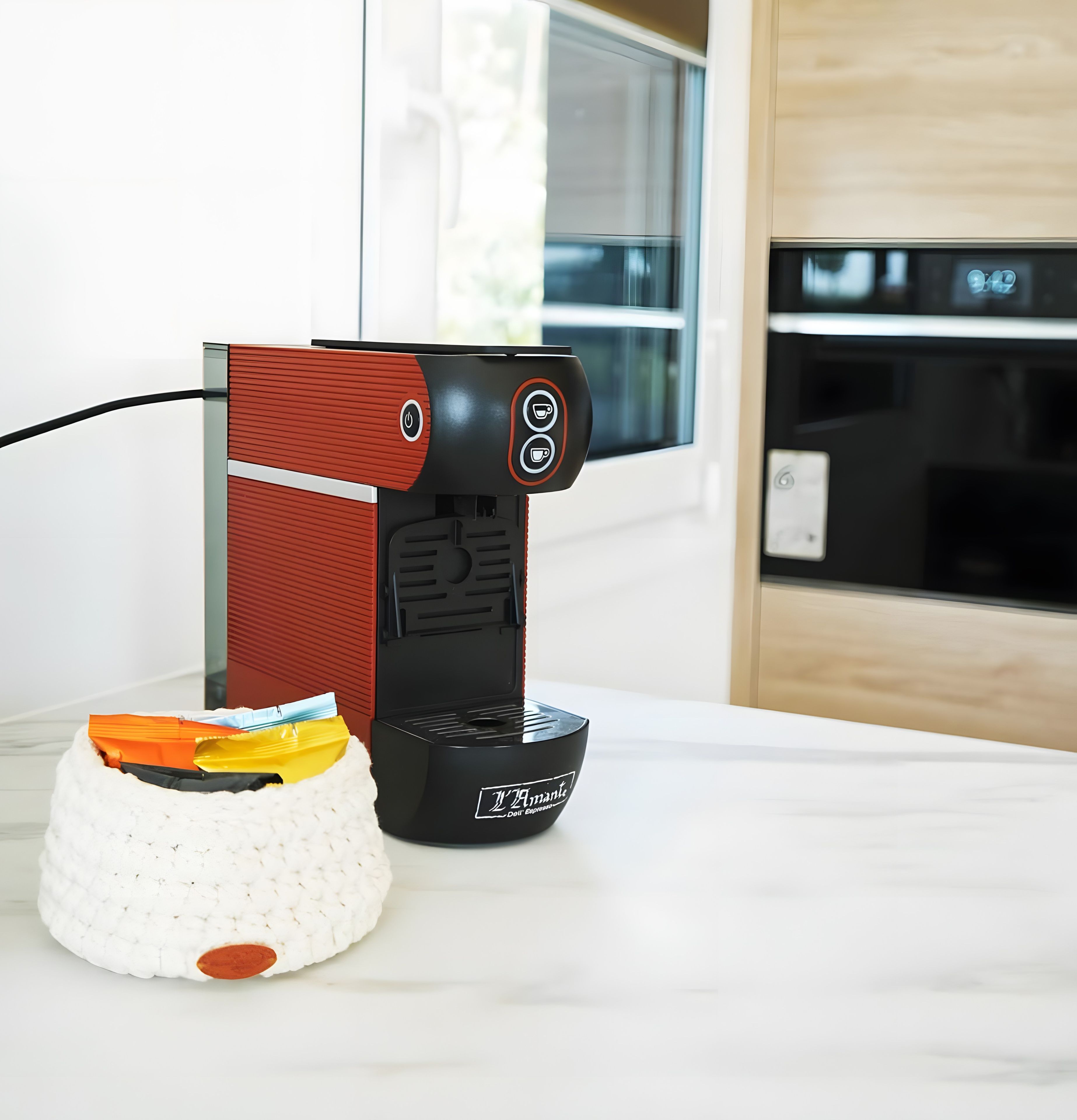 A coffee machine with a control panel and a white basket with a lid on a countertop.