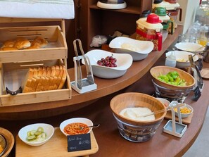 A buffet setup with various food items and condiments. - S Class (Seoul)