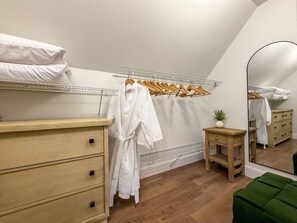 A bedroom with a bunk bed, wooden dresser, mirror, and hanging clothes rack. - Arden Legacy Retreat: Pool, Sauna, Hot Tub, Game Room, Theater (Avery Creek)