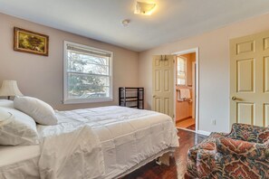 A bedroom with a bed, a window, a door, and a chair. - Group-Ready Nashville Home Near Downtown! (Nashville)