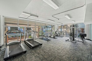 A gym with treadmills, elliptical machines, and weight equipment. - Malibu Pointe 1001 -I/O Pools-Lazy River-4BR/4BA (North Myrtle Beach)