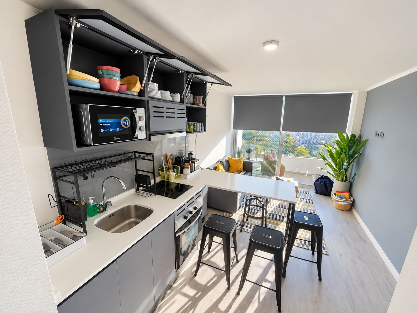 A modern kitchen with a built-in microwave, a sink, and a dining area with stools.