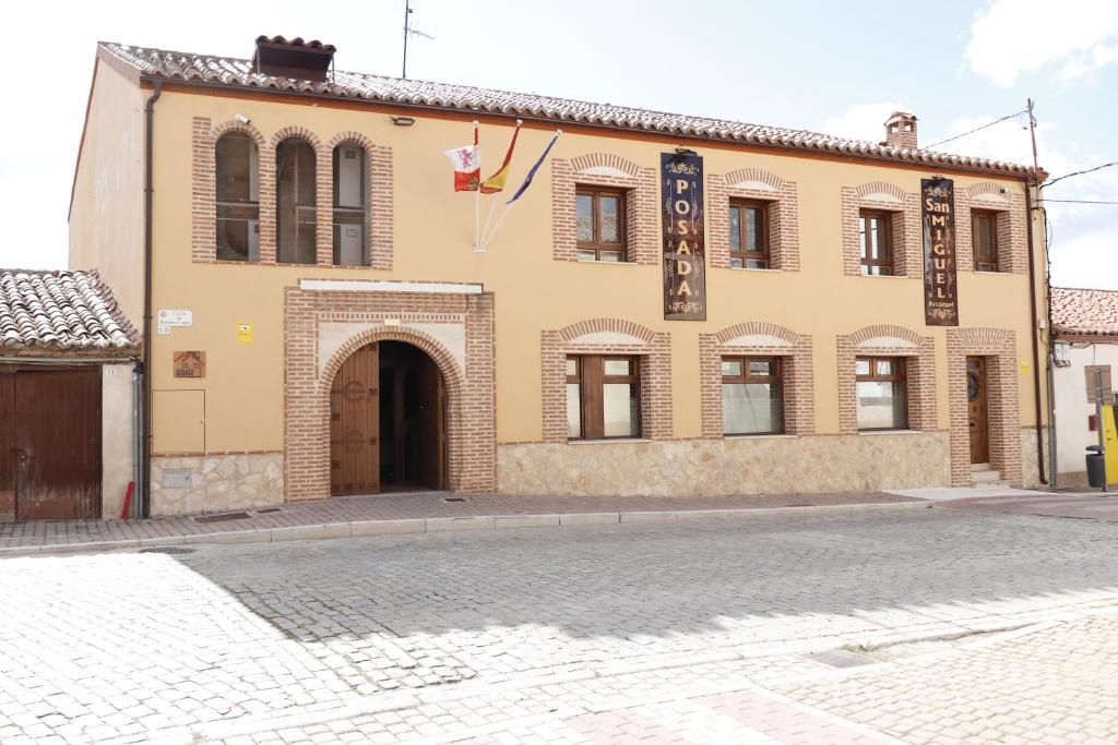 A building with a sign reading 'POSADA San Miguel' and a flag.