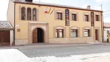 A building with a sign reading 'POSADA San Miguel' and a flag.