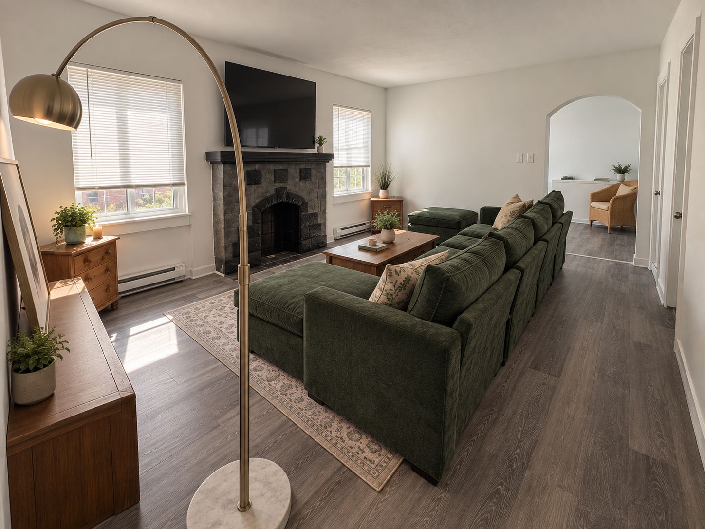 A modern living room with a sectional sofa, a fireplace, and a flat-screen TV.