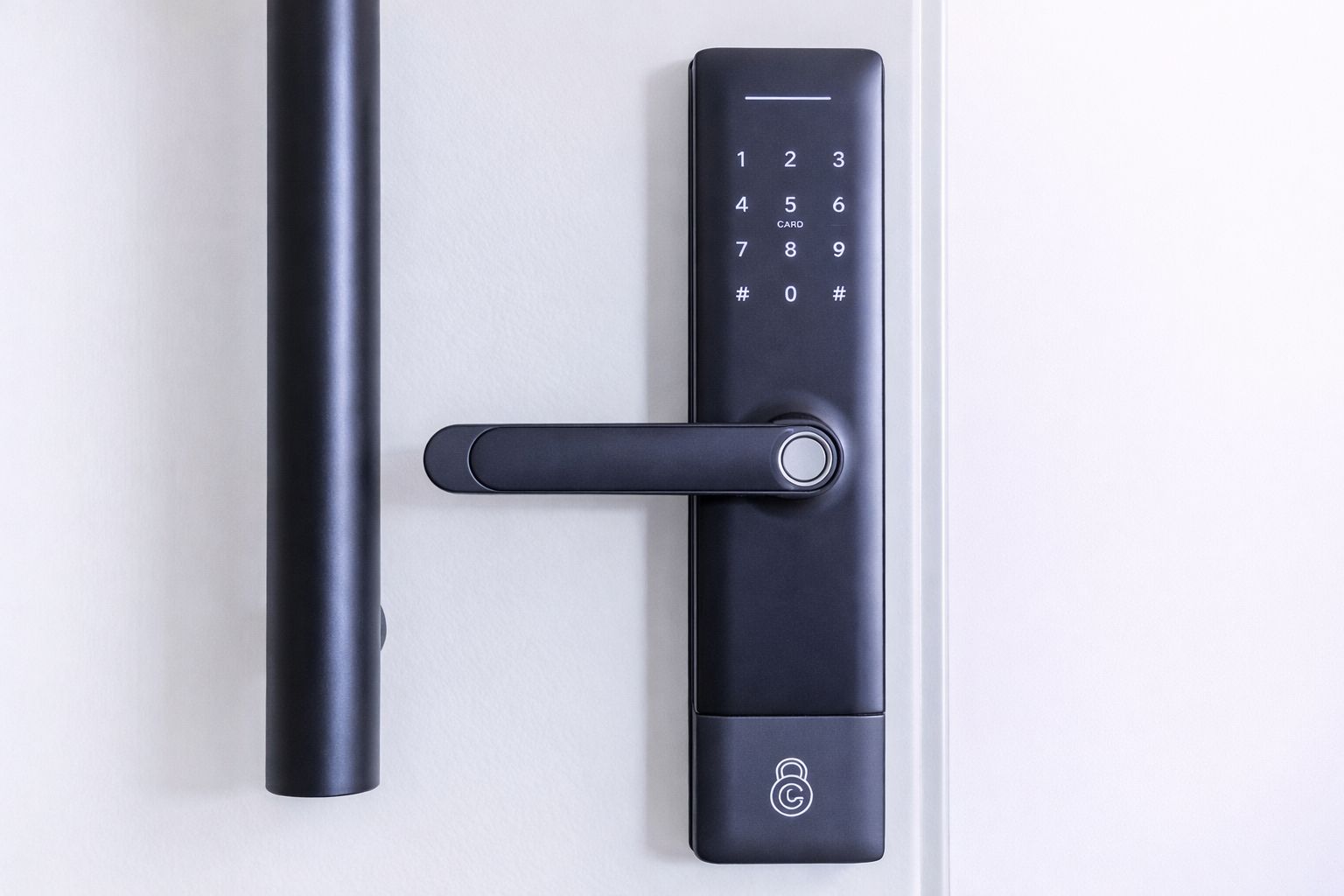 A modern door with a numeric keypad lock and a sleek handle.
