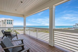 A covered deck with a view of the beach and ocean. - Amberjack | 7BR | Heated Pool & Spa | Sleeps 16 (Inlet Beach)