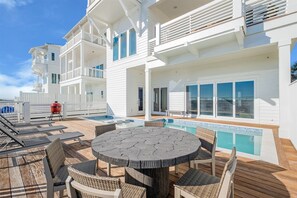 A multi-level outdoor deck with a pool, lounge chairs, and a barbecue area. - Coastal View | Gulf Views | Pool & Hot Tub (Inlet Beach)