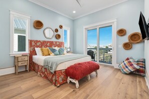 A bedroom with a bed, bedside tables, a window, and a view of the outside. - Coastal View | Gulf Views | Pool & Hot Tub (Inlet Beach)