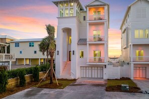 A multi-story residential building with a central staircase, a covered porch, and a garage. - Coastal View | Gulf Views | Pool & Hot Tub (Inlet Beach)