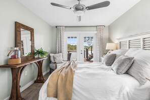 A bedroom with a bed, a desk, a chair, a ceiling fan, and a view through a door. - 🚲Lakeside Villa | Private Dock, Kayaks & Bikes | Minutes to 30A Beaches🏖️ (Seacrest)