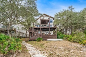 A two-story house with a wooden deck and stairs leading to a balcony. - 🚲Lakeside Villa | Private Dock, Kayaks & Bikes | Minutes to 30A Beaches🏖️ (Seacrest)