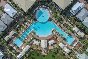 A resort with multiple swimming pools, lounge areas, and a central circular water feature. - Sea Sanctuary | Pool | 3 Balconies | Near Beach (Seacrest Beach)