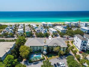 An aerial view of a coastal residential area with multiple buildings, a swimming pool, and a view of the ocean. - 🏖️Seagrove Shores Spacious Coastal Retreat | Steps from the Beach | Sleeps 4🏖️ (Santa Rosa Beach)