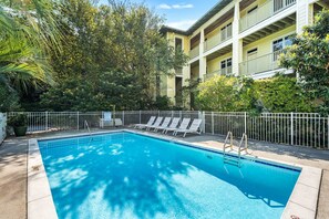 A rectangular swimming pool with a white metal fence and lounge chairs. - 🏖️Seagrove Shores Spacious Coastal Retreat | Steps from the Beach | Sleeps 4🏖️ (Santa Rosa Beach)