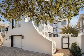 A modern residential building with a white exterior, a curved staircase, and a gated entrance. - 🚲Stepping Stone Carriage House- Bikes- Inlet Beach🚲 (Inlet Beach)