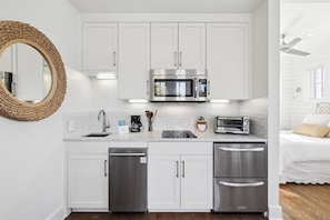 A modern kitchen with white cabinetry, stainless steel appliances, and a microwave. - 🚲Stepping Stone Carriage House- Bikes- Inlet Beach🚲 (Inlet Beach)