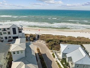 A coastal property with a beach view, a flagpole, and a road leading to the beach. - 🚲Stepping Stone Carriage House- Bikes- Inlet Beach🚲 (Inlet Beach)
