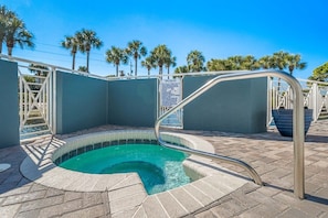 A small outdoor hot tub with a metal ladder, surrounded by palm trees and a clear blue sky. - ☀️Sun Stone | Steps from Beach | Pool | Sleeps 6☀️ (Santa Rosa Beach)