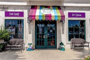 A storefront with a colorful awning, a sign for 'Cool Candy,' and a sign for 'Ice Cream.' - Village of South Walton F307-Vitamin Sea | Condo | Pool & Hot Tub | Sleeps 8 (Alys Beach)