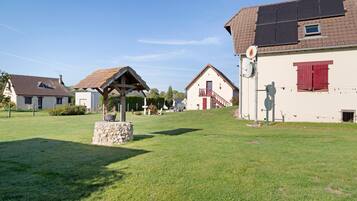 A residential area with houses, a stone monument, and a clear sky.