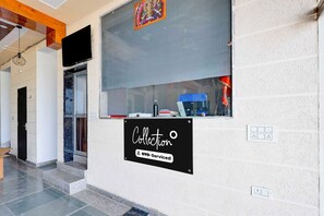 A hotel interior with a sign indicating it is serviced by OYO.